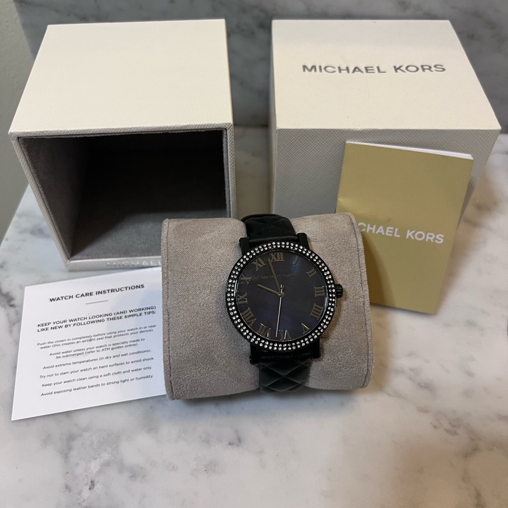 Michael Kors Black watch with mother of Pearl face and rhinestones.
